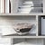 This contemporary flared bowl is a play on abstract, deconstructed design. Fashioned from aluminum, it has a raw, hand...
