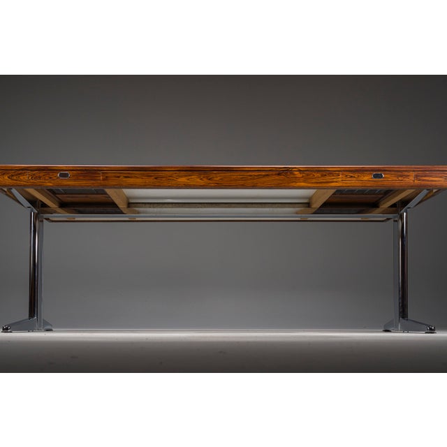Elegant executive desk produced in the 1970s, featuring a beautifully figured palisander veneer top supported by refined...