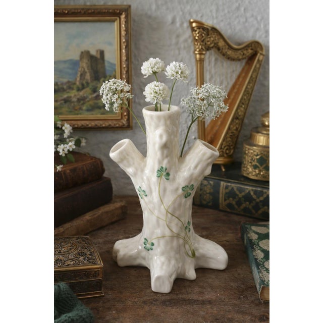 This charming vintage Belleek Ireland porcelain vase features a whimsical tree trunk form adorned with delicate hand-...