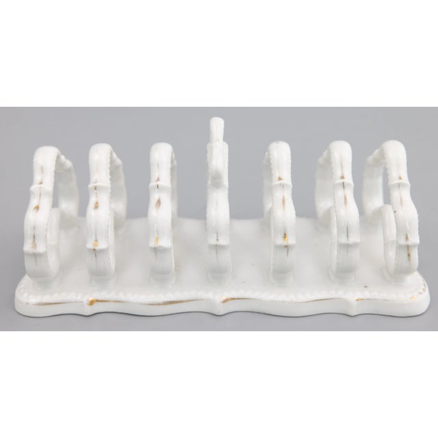 A lovely antique English white ironstone six slice toast rack, circa 1910. This beautiful toast rack has lovely gilt...