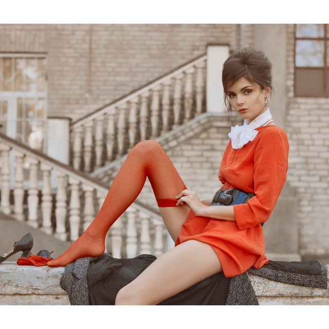 The Wish by Dasha and Mari Stairs and stockings, a model perches on a ledge in vibrant red. Limited edition print (edition...