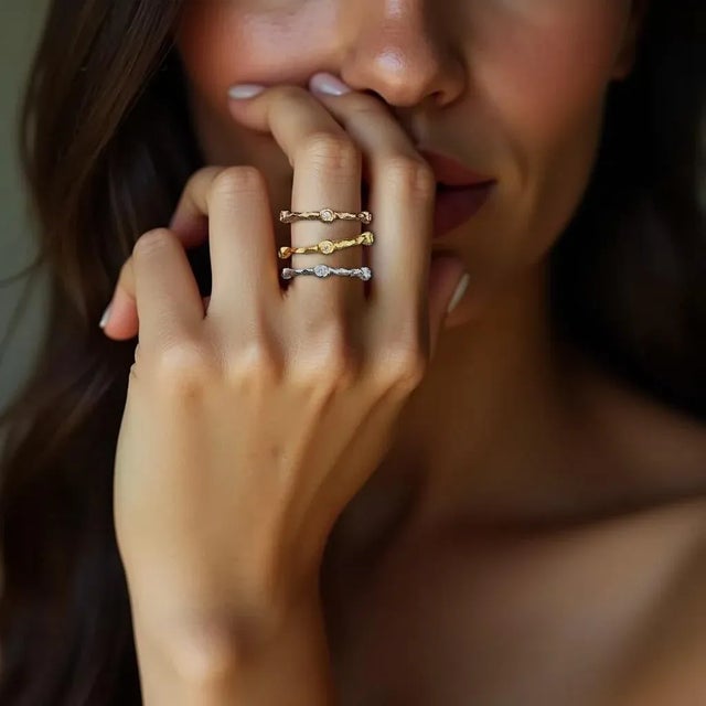 This exquisite 18K gold band features a nature-inspired textured design, beautifully complemented by sparkling diamonds....