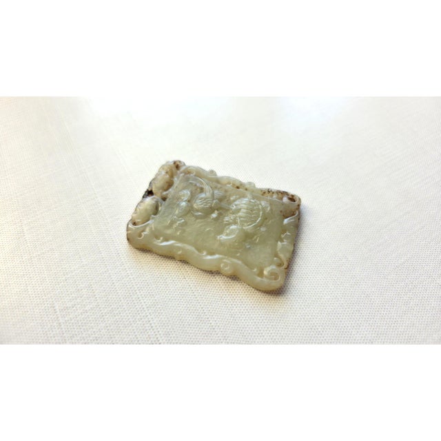We are pleased to present a very old pendant-amulet crafted from Hetian jade, featuring a carved depiction of a bird on a...