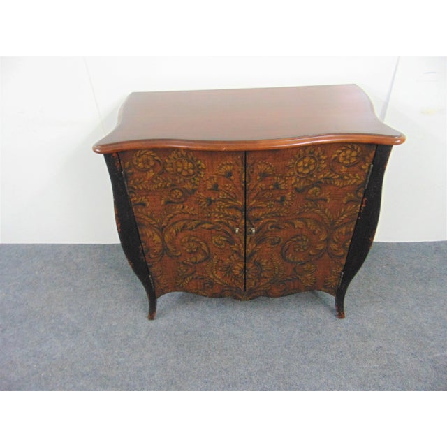 Louis XV style commode , top is cherry , black paint distressed legs, doors and side are floral decorated, shelf inside