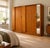 A mid century Austinsuite teak wardrobe with a space-saving tambour door and recessed handle. The interior includes a...