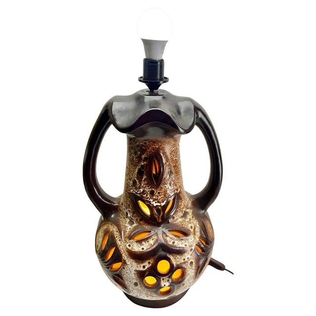 Dramatic fat lava floor lamp in green and brown glazes on a neutral stoneware ground, with a narrow neck, overload base...