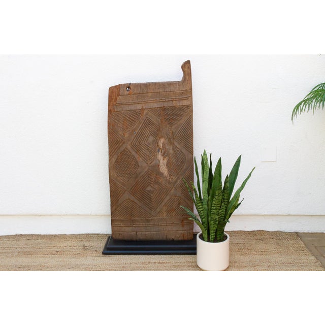 Hand-carved from a single length of hardwood, this door is deeply rooted in the artistic traditions of the Dogon people of...