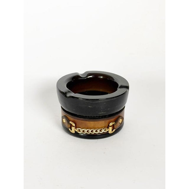 Decorative French ashtray dating from the 1970s, featuring a cylindrical form in dark smoked glass. The base is...