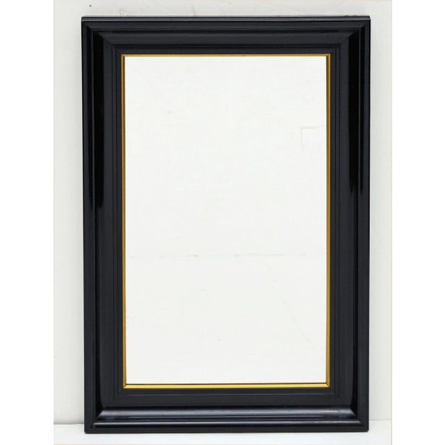 A fine vintage French rectangular wall mirror with black painted turned wood frame and gilt accents around the mirrored...