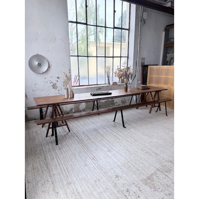 A set comprising a very large farmhouse table on trestles, accompanied by two large benches. we love its xxl size, 4...
