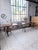 A set comprising a very large farmhouse table on trestles, accompanied by two large benches. we love its xxl size, 4...