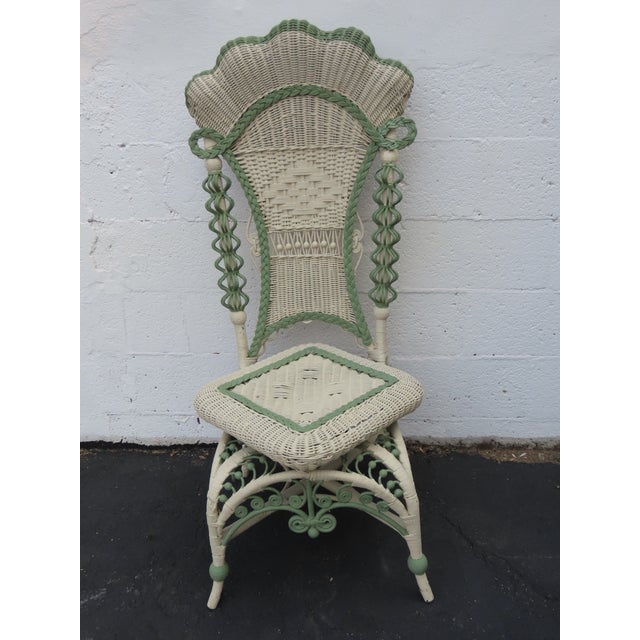 This exquisite Victorian late 1800's Side Chair is made of woven wicker or rattan, painted primarily in an off-white color...