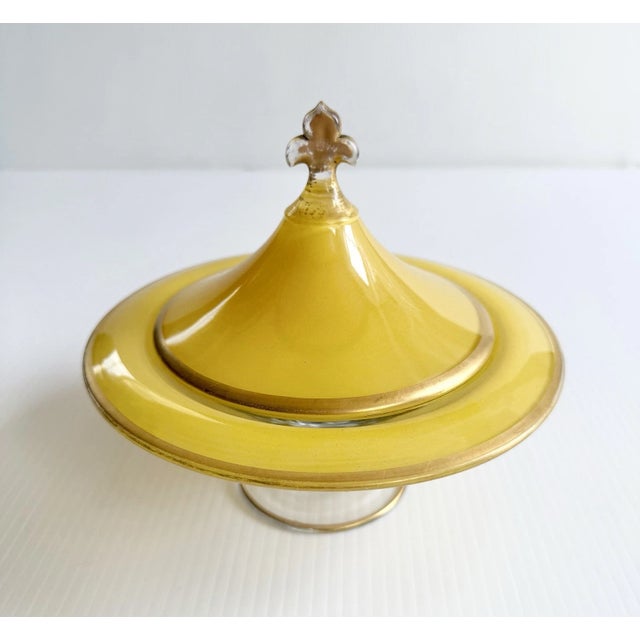 Unique and charming yellow stained glass pedestal dish with gold details.