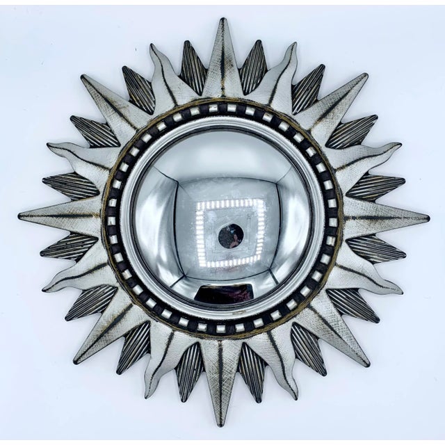 A radiant silver Italian sunburst mirror with convex glass, circa 1950. This is a lovely sunburst mirror with a unique...