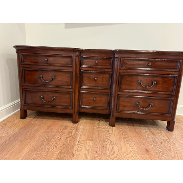 Stately mahogany wood dresser from Milling Road by Baker Furniture. This piece has a dark brown finish with a distressed...