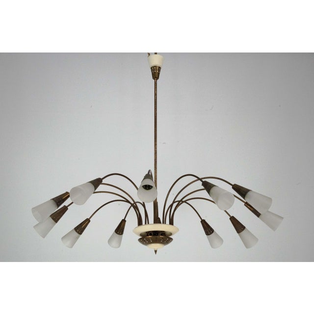 Striking Italian Mid-Century chandelier from the late 1950s featuring a dynamic Sputnik design with multiple curved arms...