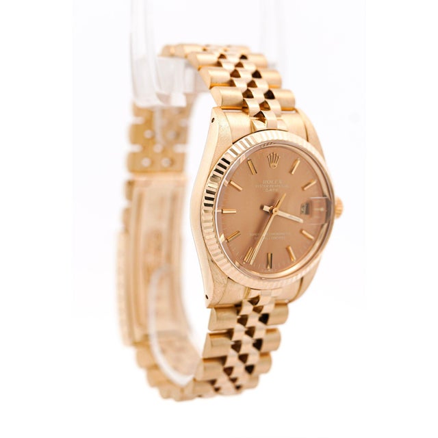 Vintage 1986 Rolex Oyster Perpetual Date in 14K yellow gold featuring 34mm case with a champagne dial, fluted bezel, and...