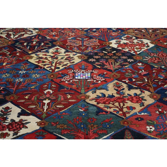 This central Persian Char Mahal district village scatter shows a Scali form escutcheon pattern in ecru, red, navy medium...