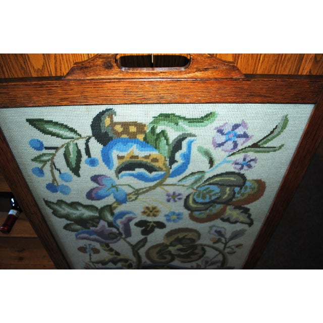 Early 1900's needlepoint fireplace screen with a beautiful Jacobean floral design. It is framed in quarter sawn oak. This...