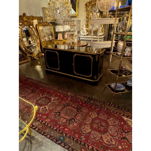 The 19th Century French Black Lacquered Traditional Sideboard with gilt bronze details exudes elegance and charm with its...