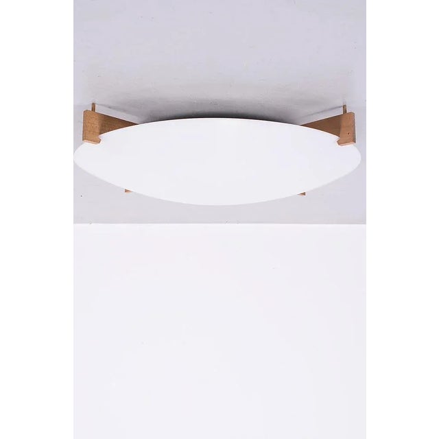 Model 'Plafo' ceiling lamp produced by Luxus is designed by Uno & Östen Kristiansson. Measurements H. 11 cm; Ø 60 cm. Up...