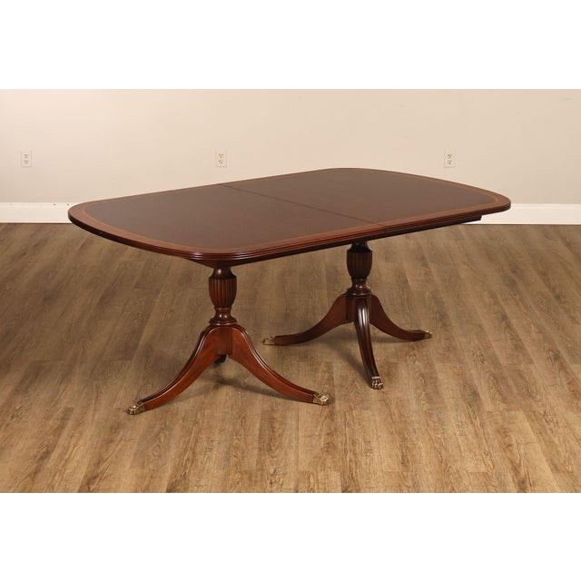 High Quality American Made Rectangular Expandable Banded Mahogany Dining Table On Double Pedestal Base with Brass Capped...