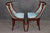 An elegant and highly refined set of four French Empire style side chairs, executed with remarkable sophistication and...