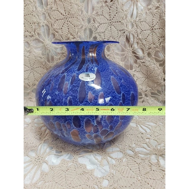 Beautiful hand blown blue art glass vase featuring shimmering copper flake (aventurine-style) inclusions that catch the...