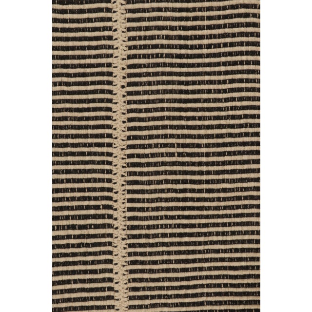 This 8x10 Rez Kilim balances graphic black striping with soft ivory fields in a refined flatweave design. Its rhythmic...