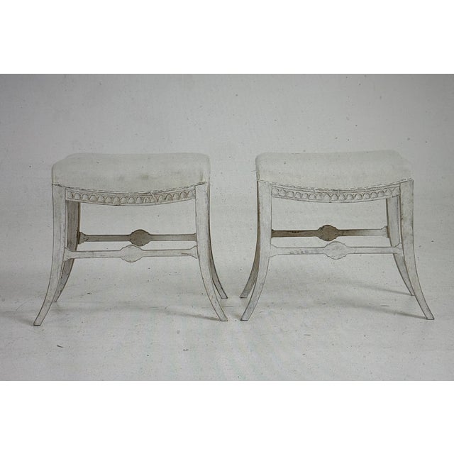 A magnificent pair of 19th-century stools in perfect form and color. Cutwork and shell decoration, along with saber-shaped...