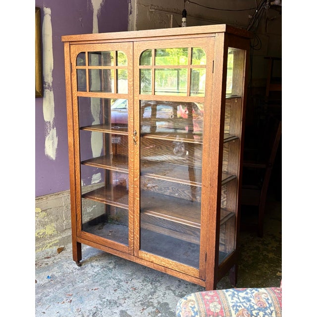 Stunning cabinet possible made by the Larkin Furniture co. but it is unsigned. Original glass, casters and finish with no...