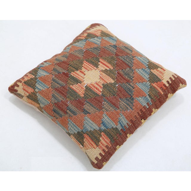 A one-of-a-kind handwoven Afghan wool kilim accent pillow featuring diamond lattice with a central hourglass on rust. Cut...