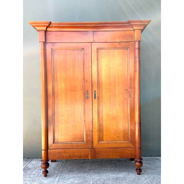 Command attention with this stately neoclassical armoire by the esteemed French maker Geka. Expertly crafted from solid...