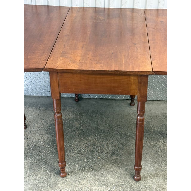 Lovely Sheraton style gateleg table circa early 19th century. Features drop leaves supported via turned gate legs and a...