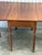 Lovely Sheraton style gateleg table circa early 19th century. Features drop leaves supported via turned gate legs and a...