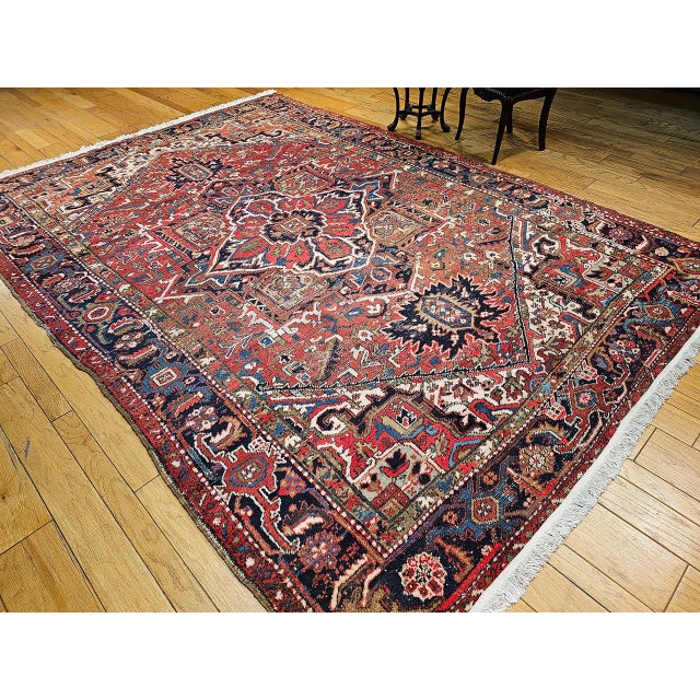 "This exquisite vintage Persian Heriz rug, dating from the first quarter of the 20th century, is a striking example of...