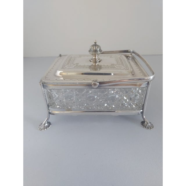 A vintage plated silver sardine serving dish from England. There are three pieces. The glass is crystal. The height with...