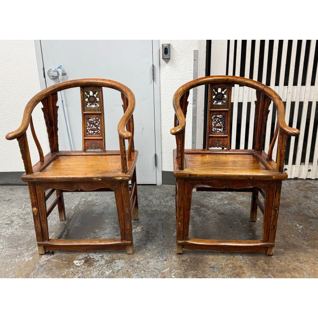 Design Plus Gallery presents a Pair of Antique Chinese Horseshoe Armchairs. Sweeping curved backs extend into rounded...