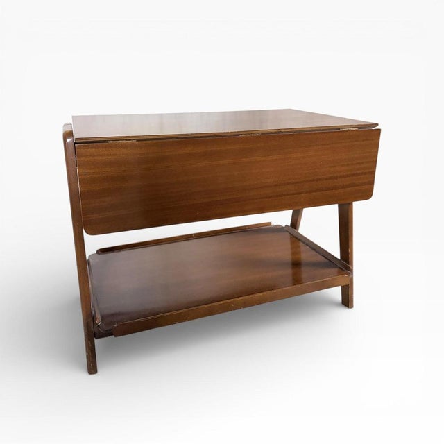 A beautifully proportioned mid-century walnut drinks trolley by Remploy, showcasing the clean lines and practical elegance...