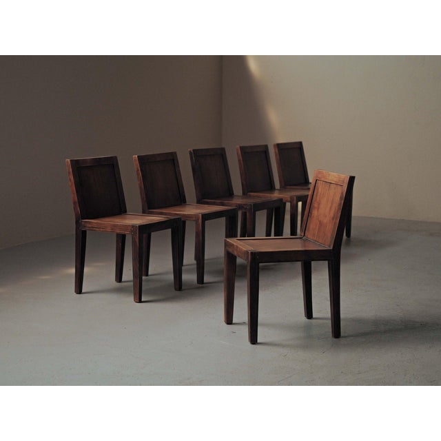 Set of six chairs, crafted in solid oak and oak veneer, they embodies a restrained and architectural aesthetic...