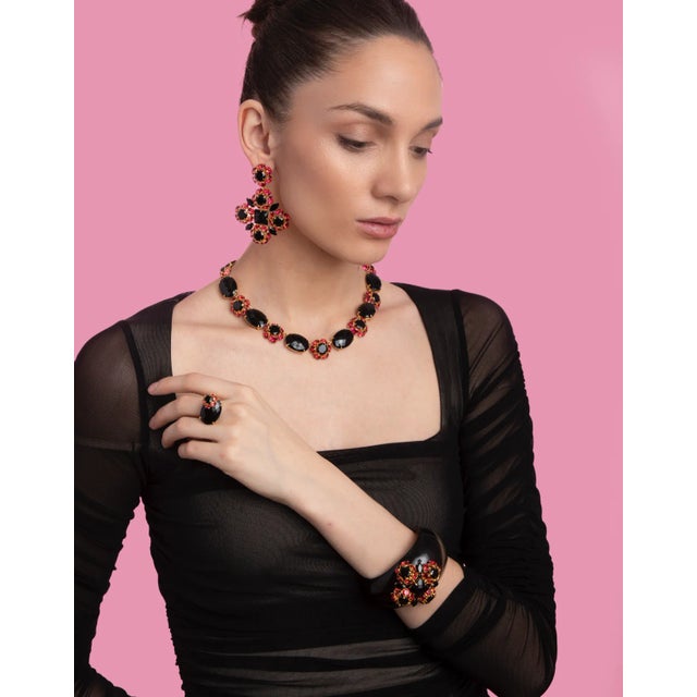 The Fleur Earrings, crafted from semi-precious stones, feature a detachable bottom allowing for the standalone wear of the...