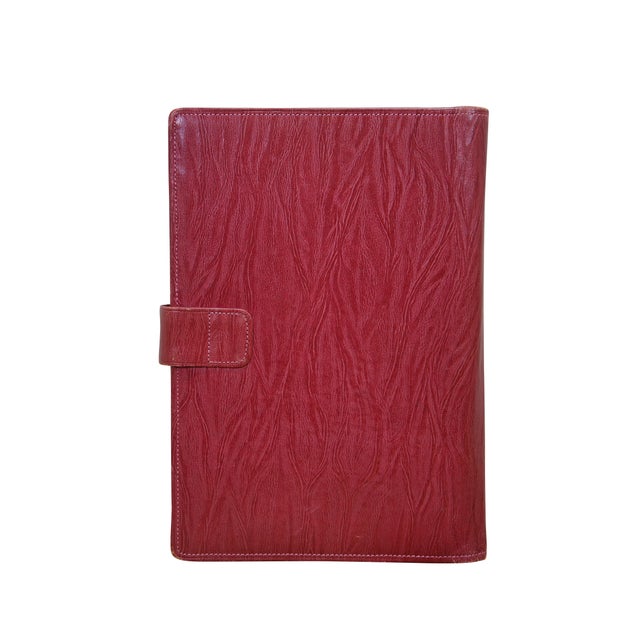 Vintage red leather textured planner with lock and key, circa 1970s. Features a pencil holder, calender sleeve, central...
