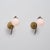 Pair of italian wall sconces from the 1950s, combining a sculptural brass structure with spherical opaline glass diffusers...