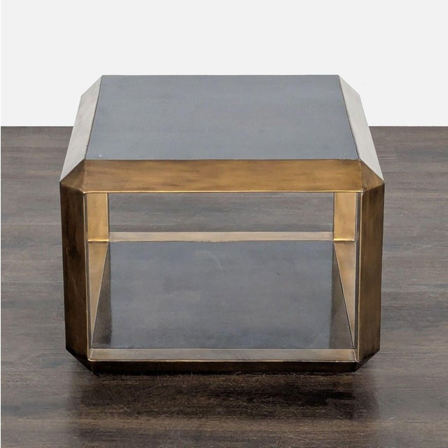 Fossilized stone top and shelf with aged brass frame. Original Price: $1150. Dimensions (in): 24W x 24D x 18H.