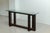 Constructive console table produced in Italy around 1980. This table has a solid dark stained wooden frame with a glass...