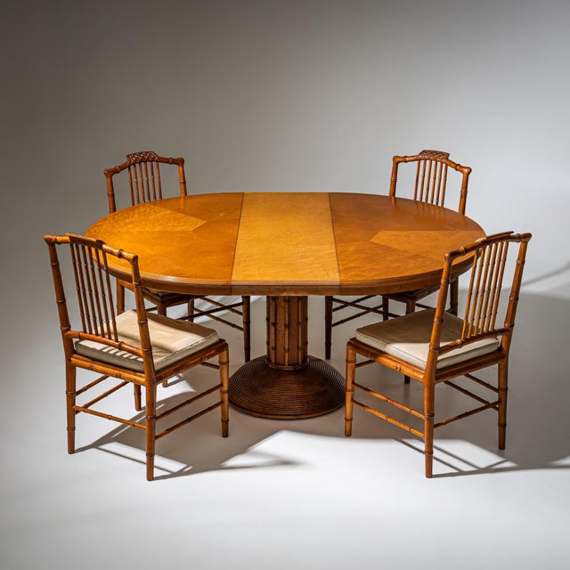 Dining group consisting of a round extension table and four matching chairs in the faux bamboo style. The table extends to...