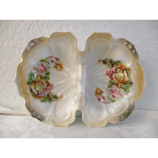 Beautiful German porcelain large handled divided bowl delicately hand-painted in a rose motif. Marked underside "Germany."