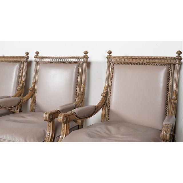 A striking and highly composed set of four Louis XVI-style fauteuils, defined by their architectural clarity, refined...