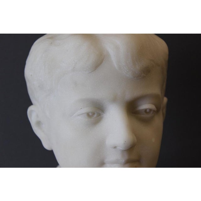 Carrara marble bust representing a young man, original marble base height 5.5 cm, signed, dated and located Paris 1931,...