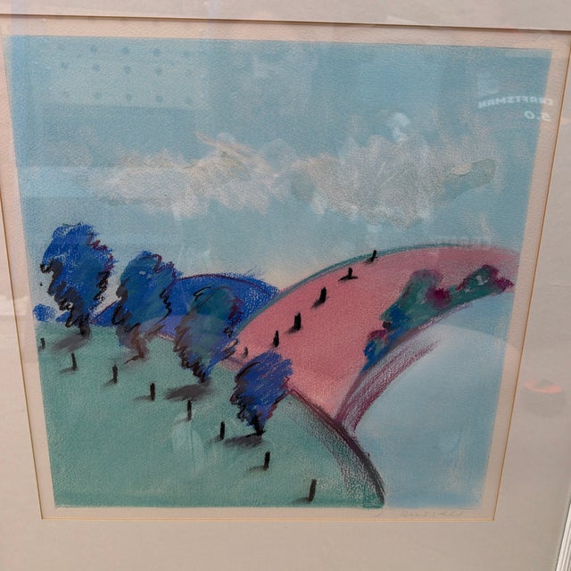 Framed pastel landscape by artist J. Russell. Soft blue sky with white clouds over rolling green hills, a cluster of blue...